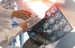 Stock image depicting MRI brain scan x-ray with radiologist and oncologist team in hospital clinic.