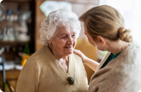 Stock photo of health visitor talking to a senior woman during home visit. 